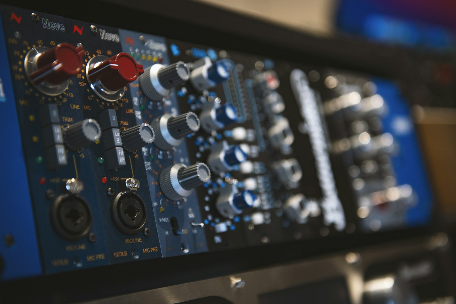 Home 2 Close-up of a music studio mixing console used to master hip-hop tracks